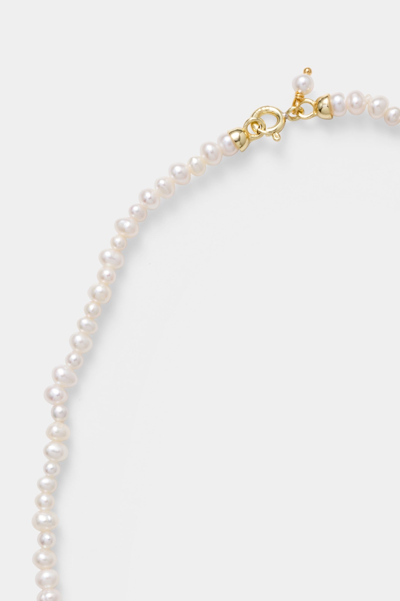 Detail van de parels en sluiting van de Labro Piccolo Pearl Necklace met drie strikken